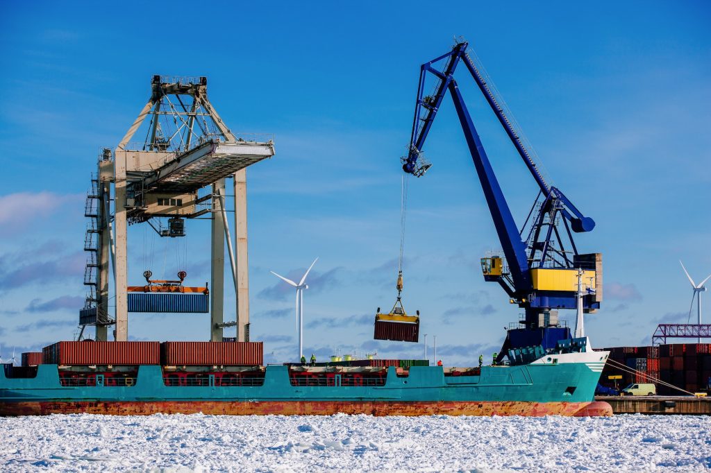 Industrial port with containers, vessel loading in port of Finland